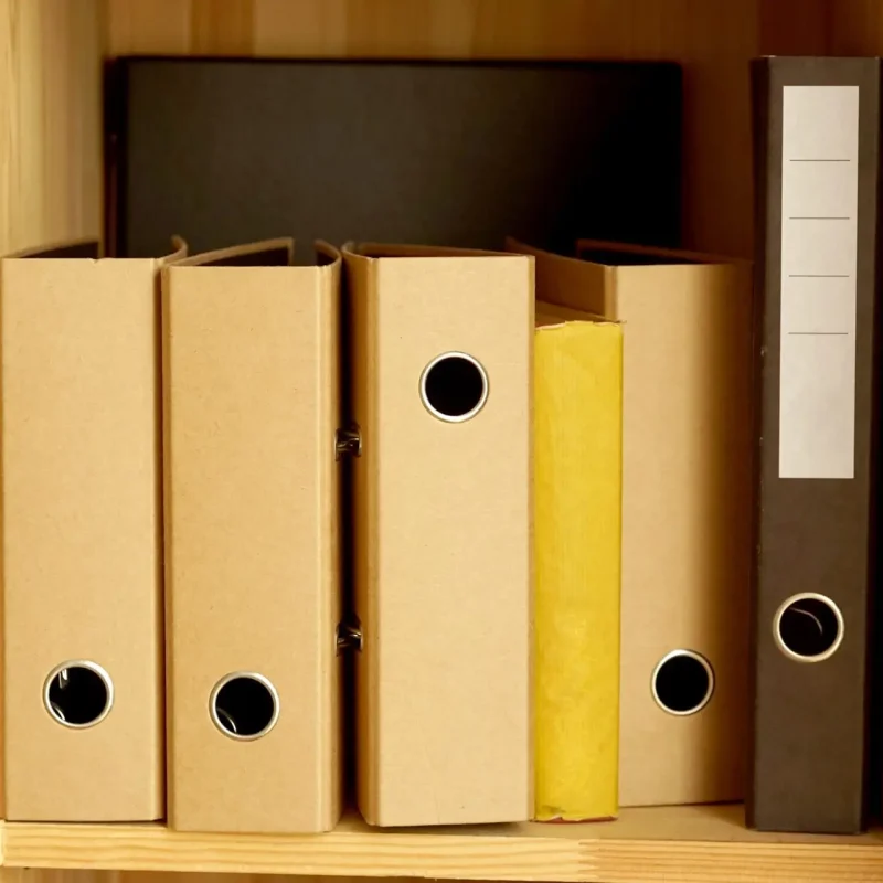 Folders stand on the shelf in the office